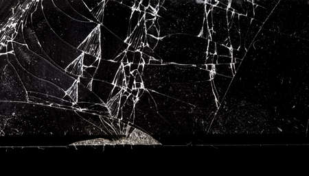 Broken black glass as background. Close-up