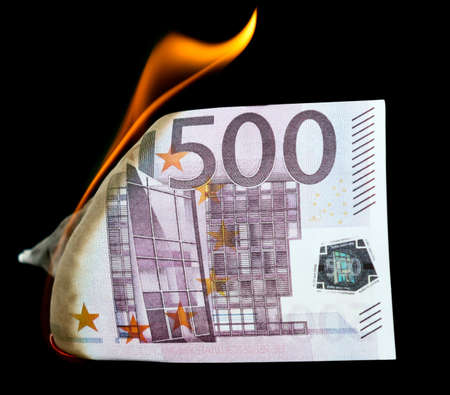 Five hundred Euros are burning on a black background.