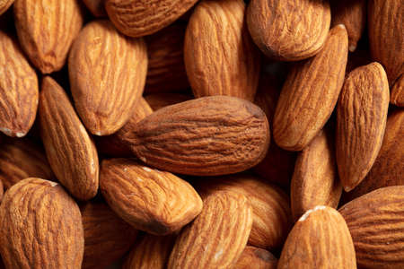 Close up of almond nuts as background. Macro