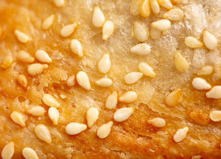 Sesame seeds on a crust of bread as a background. Close-upの写真素材