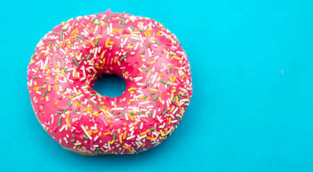 Red donut on a blue background. Close-upの写真素材