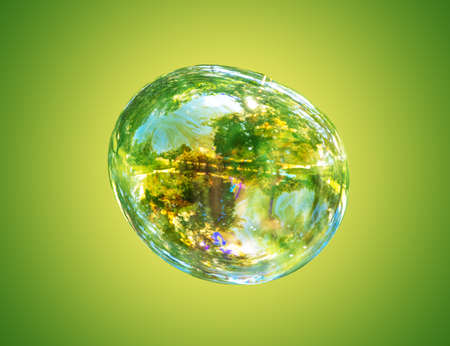 Large soap bubble on a green background.の写真素材