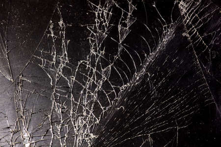 Broken black glass as background. Close-up