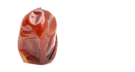 One dried date isolated on a white background.