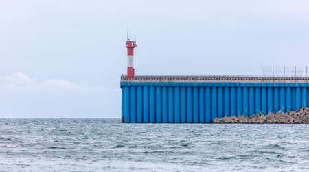 Lighthouse on a promontory near the sea. Sign for shipsの写真素材