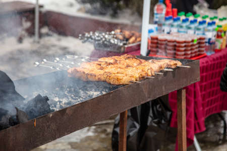 Meat on skewers is fried on the grill.