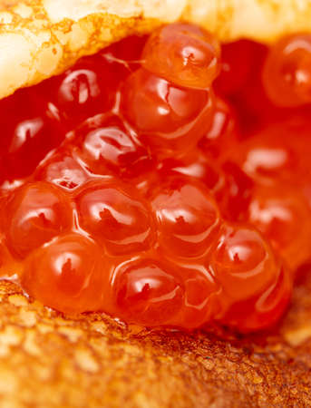Pancake with red caviar as a background. Close-upの写真素材