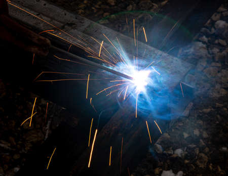 sparks from metal welding at a construction site.