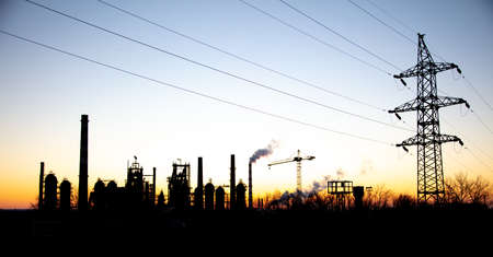 Metal poles with electric wires at sunset.