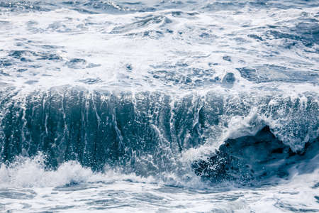 Splashing big waves on the seashore. Storm