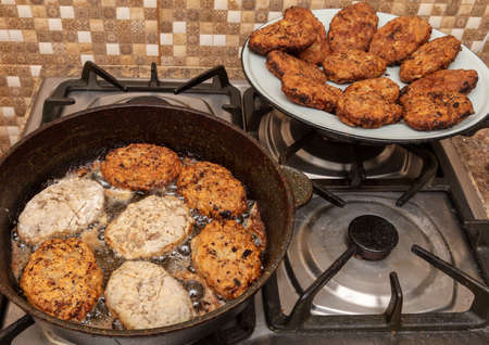 Minced meat cutlets are fried in oil in a panの写真素材