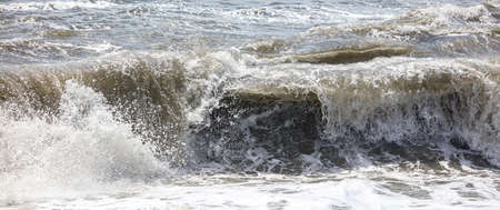Splashing big waves on the seashore. Storm