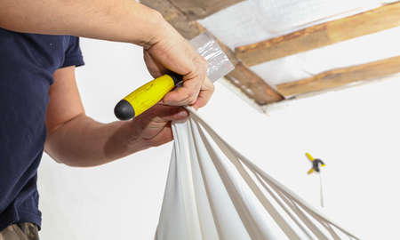 The technology of stretching the stretch ceiling in the room. Home renovationの写真素材