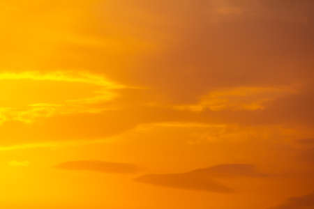 Golden sky with clouds at sunset as background.の写真素材