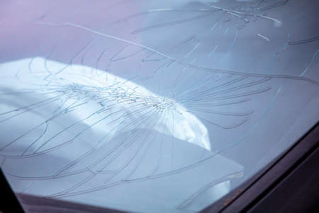 Broken glass of a car after an accident on the road.