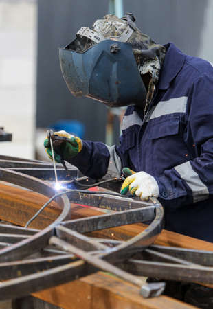 A worker welds metal at a construction site. Technologies