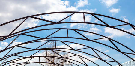 The frame of a metal canopy against the sky. Technologiesの写真素材