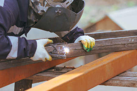 A worker welds metal at a construction site. Technologies