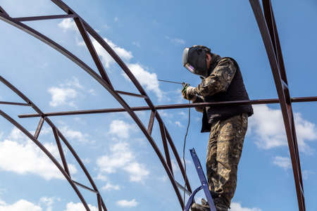 A worker welds metal to the canopy.の写真素材