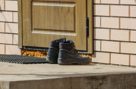 Shoes on the porch by the door.の写真素材