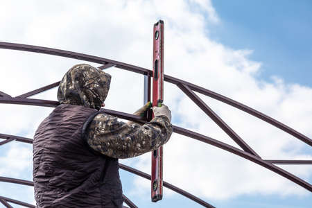 Workers are installing the metal frame of the awning. Technologies