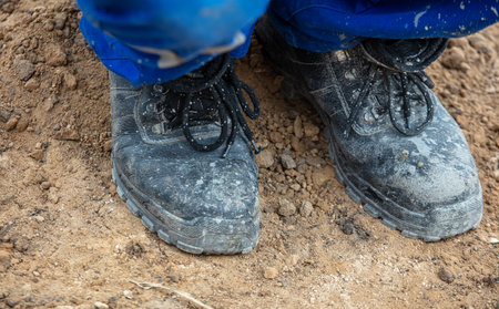 Worker shoes at a construction site. Close-up