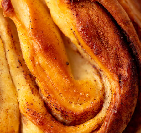 Ruddy crust on a sweet bun as a background. Close-upの写真素材