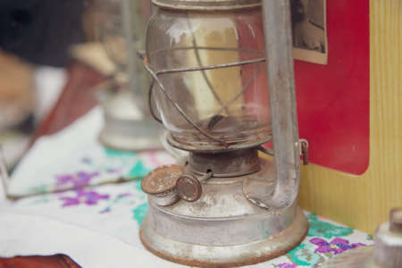 Lipetsk, Russia -May 9, 2021: Kerosene lamp on the table in the park. Holiday Victory Day over fascist Germany.のeditorial素材