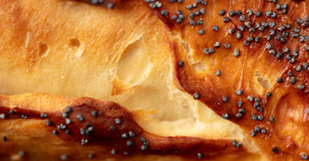 Ruddy crust on a sweet bun as a background. Close-upの写真素材