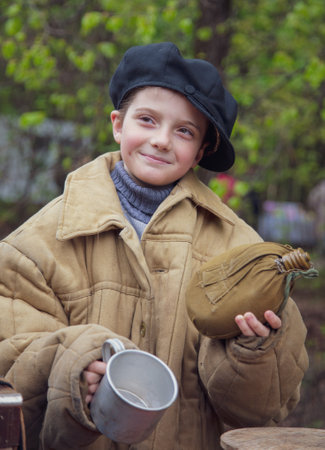 Lipetsk, Russia -May 9, 2021: Girl with antique items in the park. Holiday Victory Day over fascist Germany.のeditorial素材