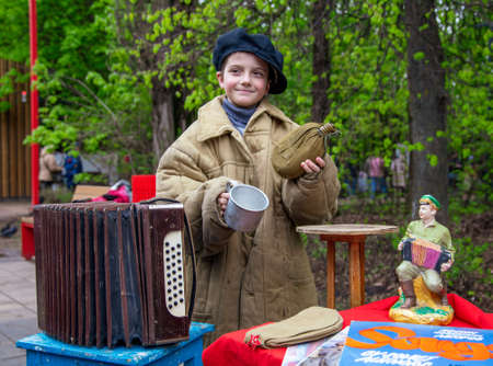 Lipetsk, Russia -May 9, 2021: Girl with antique items in the park. Holiday Victory Day over fascist Germany.のeditorial素材