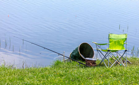 Place of a fisherman with fishing rods on the shore of the lake.の写真素材