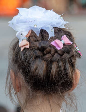 Close-up of a white bow on the girl's head.