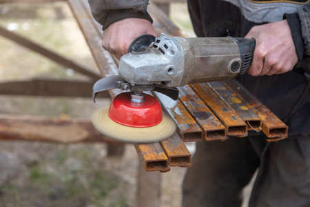A worker grinds metal at a construction site. Technologiesの写真素材