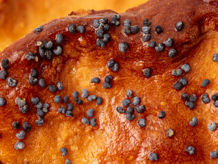 Poppy seeds on a bun as a background. Close-up