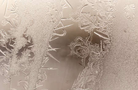 Patterns from frost on glass as a background. Close-up