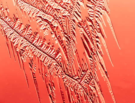 Red patterns from frost on glass as a background. Close-upの写真素材