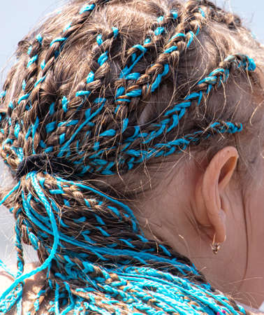 The girl has blue African braids. Close-upの写真素材