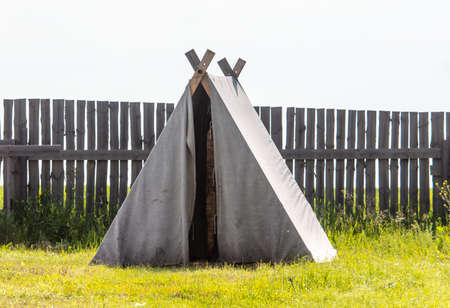 Tent in the summer park. Dwelling of ancient people
