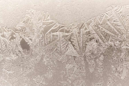 Patterns from frost on glass as a background. Close-up