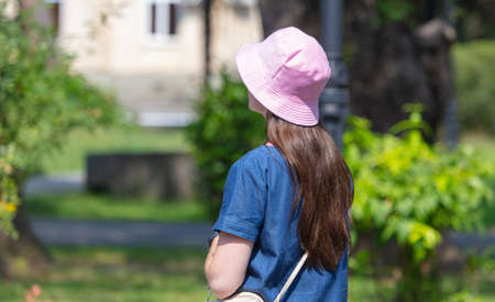 Girl in a pink cap in the park.の写真素材
