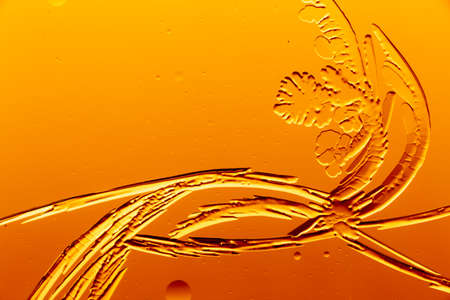 Gold patterns from frost on glass as a background. Close-up