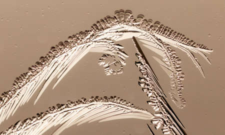 Patterns from frost on glass as a background. Close-up