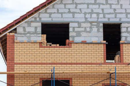Decorating the outside of the house with decorative bricks. Construction