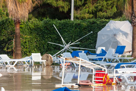 Straw loungers and sun loungers at the water park after a tornado.