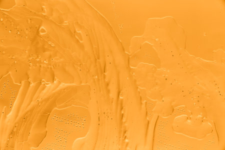 Gold patterns from frost on glass as a background. Close-up