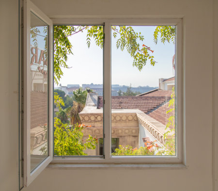 Open window overlooking the city in summer. Background