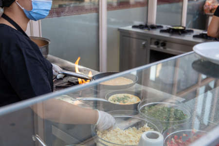 Fried eggs on the stove in a cafe.の写真素材