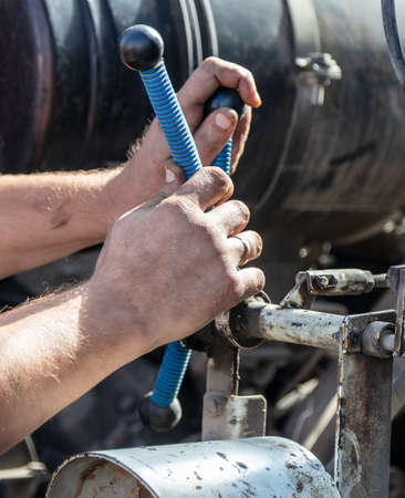 Worker repairing an engine in a truckの写真素材
