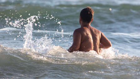 The boy swims in the sea.の写真素材